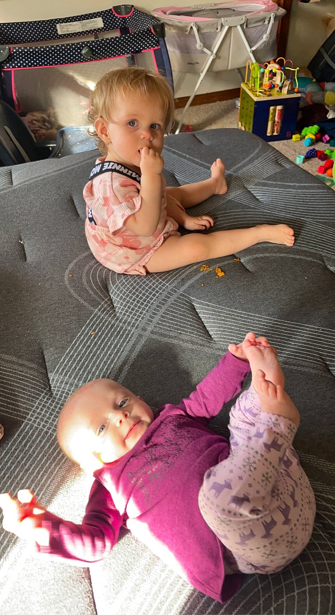 Everleigh is registered to the contest to win money with this photo: baby, baby_toddler_clothing, black, child, comfort, finger, flooring, fun, hand, lap, leg, people, person, photograph, pink, room, sitting, skin, snapshot, sock