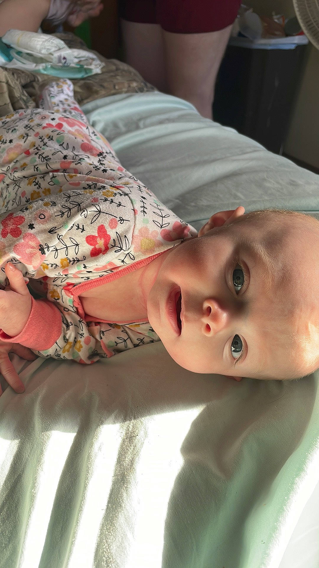 Everleigh is registered to the contest to win money with this photo: baby, cheek, child, comfort, elbow, eyelash, finger, flesh, happy, linens, lip, mammal, mouth, neck, nose, pattern, person, skin, sleeve, textile