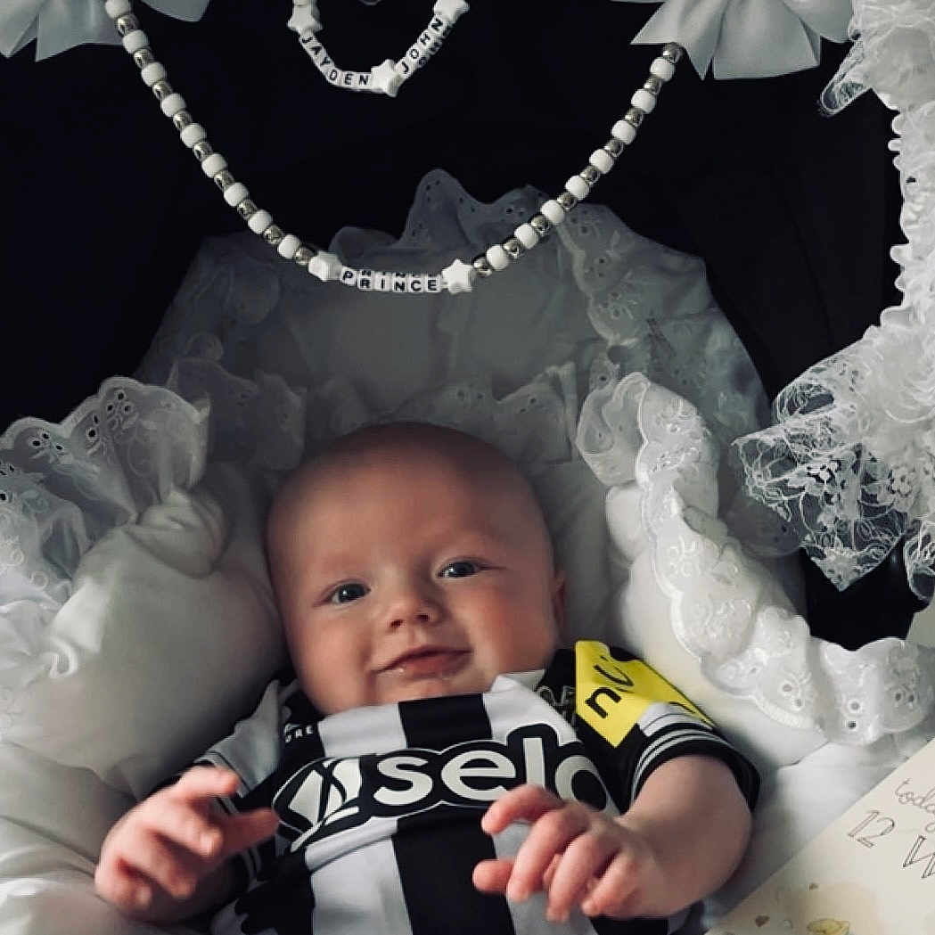 Jayden is registered to the contest to win money with this photo: accessories, baby, bed, bodypart, clothing, costume, crib, dress, earring, face, furniture, hat, head, infantbed, jewelry, necklace, newborn, person, photography, portrait