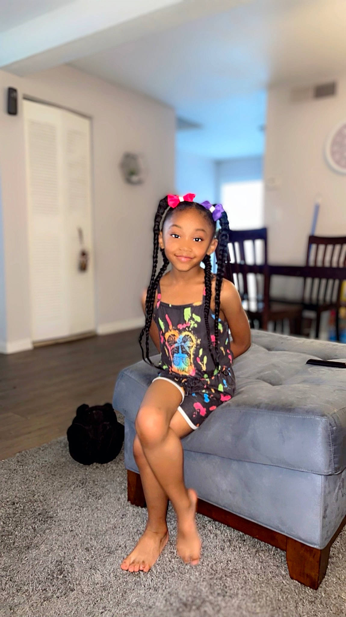 Londyn joined the competition — help win amazing prizes! barefoot, black_hair, clock, day_dress, door, electric_blue, event, fashion_design, flooring, foot, happy, human_leg, joy, leg, long_hair, one_piece_garment, person, sandal, thigh, toddler