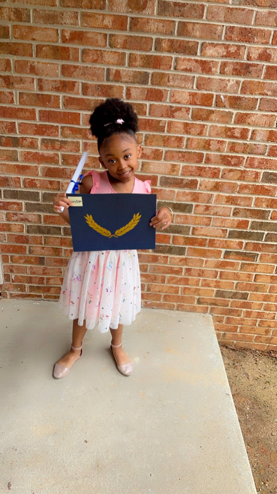 Londyn is registered to the contest to win money with this photo: baby_toddler_clothing, brick, brickwork, cap, child, clothing, electric_blue, fashion_accessory, foot, fun, hat, human_leg, joy, magenta, pattern, person, sandal, sitting, sleeve, toddler