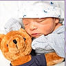 newborn, baby, teddy_bear, plush_toy, sleeping, hat, pajamas, striped_clothing, cuddle, soft_toy, child, infant, cute, cozy, peaceful, comfort, closeup, portrait, sleep, baby_clothes