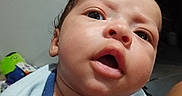 Karmello joined the competition — help win amazing prizes! baby, infant, face, portrait, curious, blue_shirt, open_mouth, close_up, skin, child, indoors, person, head, expression, young, cute, human, looking, casual_clothing, background
