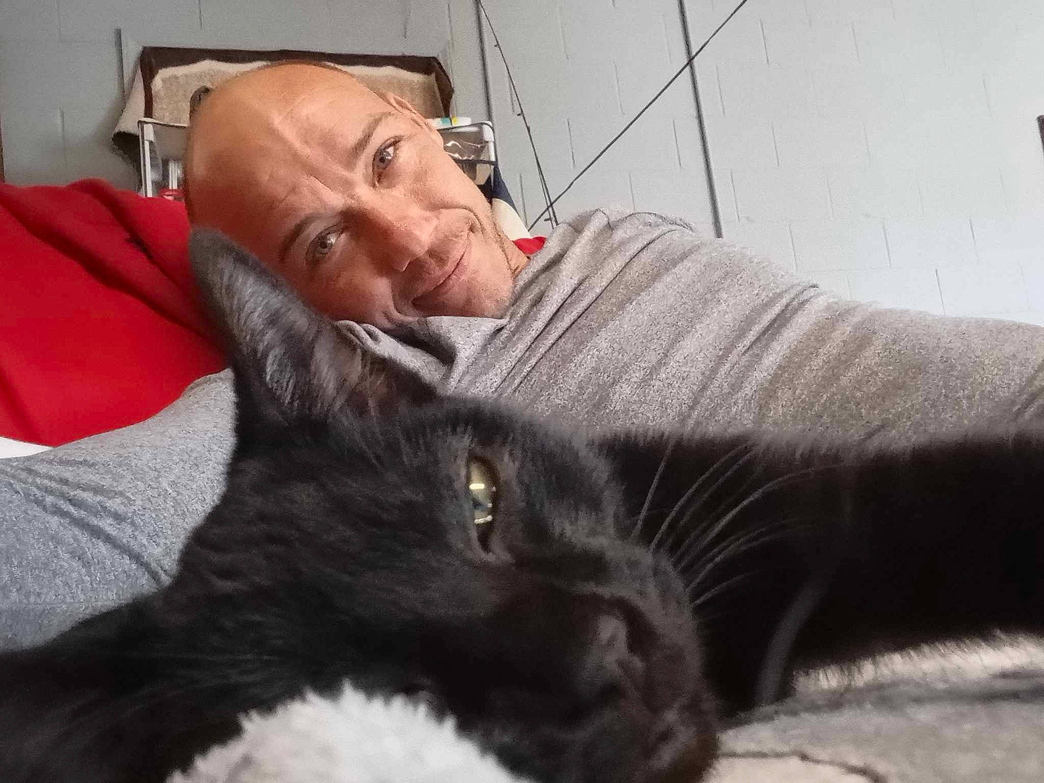 Deuce Deuce is registered to the contest to win money with this photo: beard, black_cat, canidae, carnivore, cat, comfort, domestic_short_haired_cat, ear, facial_expression, facial_hair, felidae, fur, grey, lap, mammal, sitting, small_to_medium_sized_cats, smile, snout, whiskers