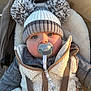 Noah joined the competition — help win amazing prizes! baby, pacifier, hat, pom_poms, vest, jacket, stroller, child, face, blue_eyes, beaded_chain, warm_clothing, outdoor, winter, cute, portrait, infant, closeup, sunlight, soft_fabric