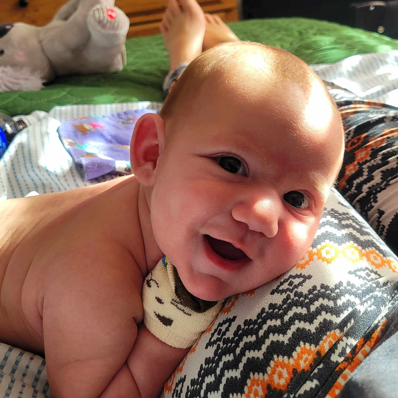 Toji joined the competition — help win amazing prizes! baby, bedroom, blanket, child, cozy, cute, face, happy, head, indoor, infant, lying_down, natural_light, patterned_clothing, person, skin, smiling, soft_toy, warm, wooden_furniture