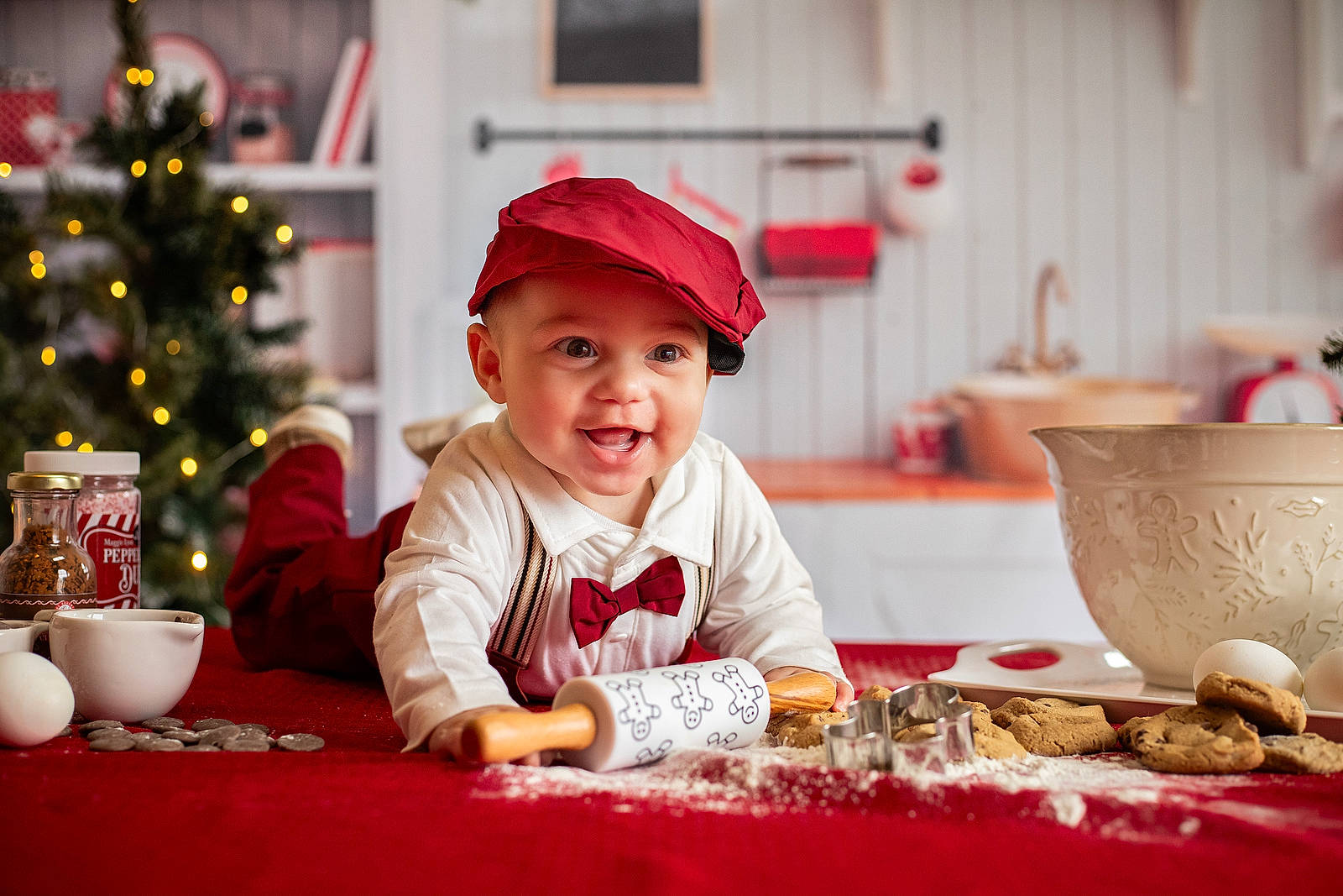 Easton joined the competition — help win amazing prizes! baby, baby_toddler_clothing, carmine, child, christmas_decoration, christmas_eve, christmas_tree, event, fun, happy, hat, headwear, holiday, joy, mixing_bowl, person, serveware, sitting, smile, table
