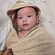 Nathaniel joined the competition — help win amazing prizes! baby, towel, hooded_towel, child, indoor, blue_eyes, face, hand, blanket, cute, wrapped, infant, portrait, soft_texture, skin, person, looking, newborn, young_child, cozy
