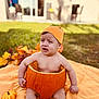 baby, child, pumpkin, orange_hat, blanket, outdoor, grass, fall_leaves, autumn, sitting, cute, costume, expression, nature, seasonal, holiday, funny, toddler, skin, daylight