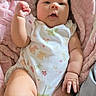 Allyson is registered to the contest to win money with this photo: baby, infant, child, portrait, lying_down, pink_blanket, floral_onesie, baby_clothing, face, eyes, hands, fist, legs, bed, bedding, cozy, indoor, home, natural_light, cute