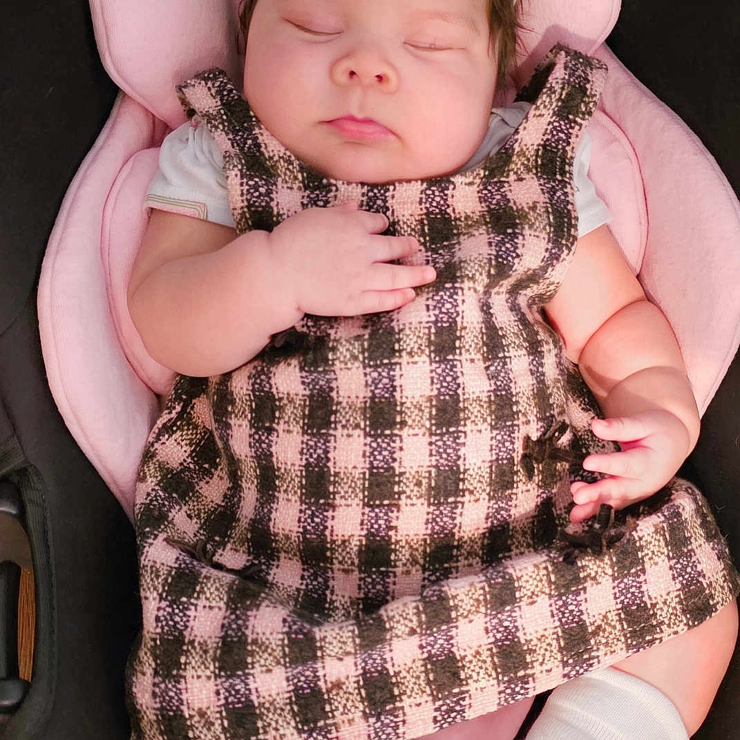 Allyson joined the competition — help win amazing prizes! baby, child, sleeping, portrait, car_seat, pink, plaid, dress, headband, bow, socks, infant, face, closed_eyes, indoors, seated, fashion, cute, photography, resting