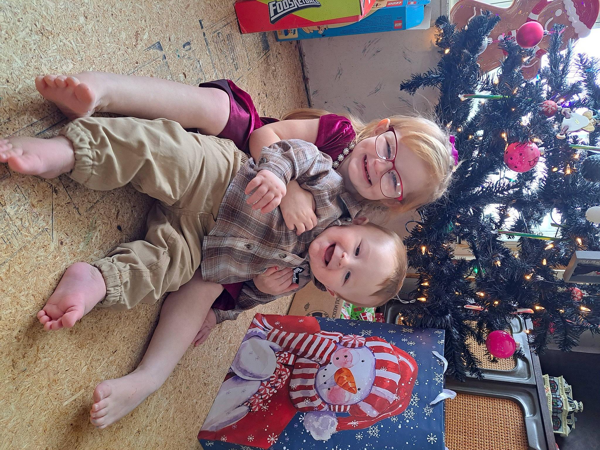 Zayn joined the competition — help win amazing prizes! baby_toddler_clothing, barefoot, child, christmas_decoration, christmas_ornament, christmas_tree, event, foot, fun, happy, holiday, holiday_ornament, human_leg, joy, lap, ornament, person, pink, smile, thigh