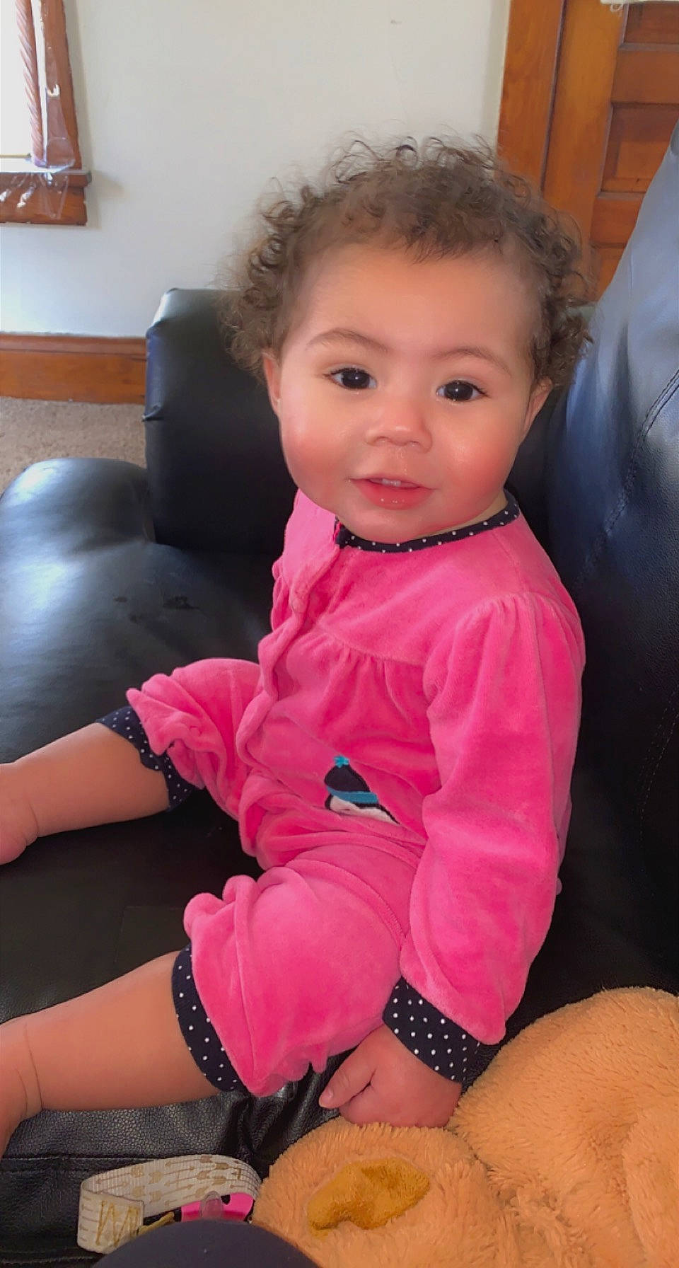 Khalani is registered to the contest to win money with this photo: arm, baby_toddler_clothing, black_hair, cheek, comfort, elbow, human_leg, joint, knee, lap, magenta, neck, person, picture_frame, pink, shoulder, sitting, sleeve, smile, thigh