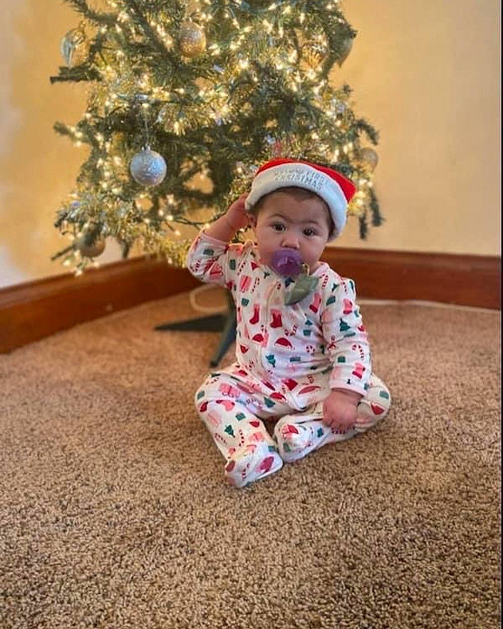 Khalani joined the competition — help win amazing prizes! baby, baby_toddler_clothing, child, christmas_decoration, christmas_ornament, christmas_tree, dress, event, flooring, happy, holiday, holiday_ornament, human_body, ornament, person, plant, sitting, sleeve, toddler, tree