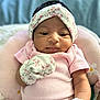 Terryana joined the competition — help win amazing prizes! baby, infant, pink_clothing, mittens, headband, floral_pattern, cushion, plush, soft_fabric, portrait, closeup, indoors, cute, newborn, child, person, skin, face, expression, comfort
