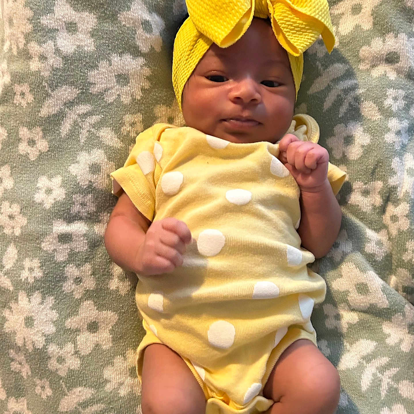 Terryana joined the competition — help win amazing prizes! adorable, baby, blanket, child, clothing, cute, floral_pattern, headwrap, indoors, infant, lying_down, onesie, peaceful, polka_dot, portrait, small_hands, smiling, socks, soft_texture, yellow