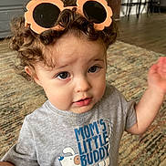 Roman joined the competition — help win amazing prizes! cabinet, carpet, chair, child, curious, curly_hair, cute, expression, face, grey_tshirt, hands_up, home, indoor, person, portrait, rug, sunglasses, text_on_clothing, toddler, wooden_floor