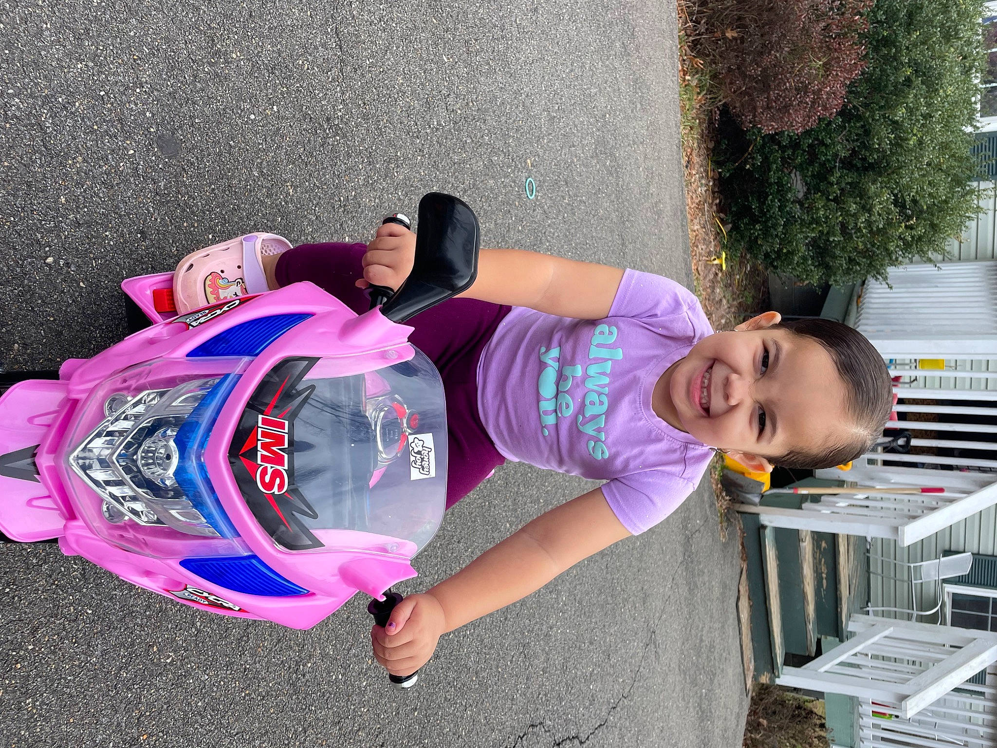Elani is registered to the contest to win money with this photo: child, electric_blue, fun, grass, joy, leisure, magenta, person, personal_protective_equipment, pink, plant, play, purple, recreation, sandal, shorts, smile, sneakers, toddler, tree
