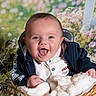 baby, basket, blanket, blue_hoodie, clothing, cute, face, floral_background, happy, infant, indoors, light, person, portrait, smile, soft_texture, white_polo, wooden_basket, young_child, greenery
