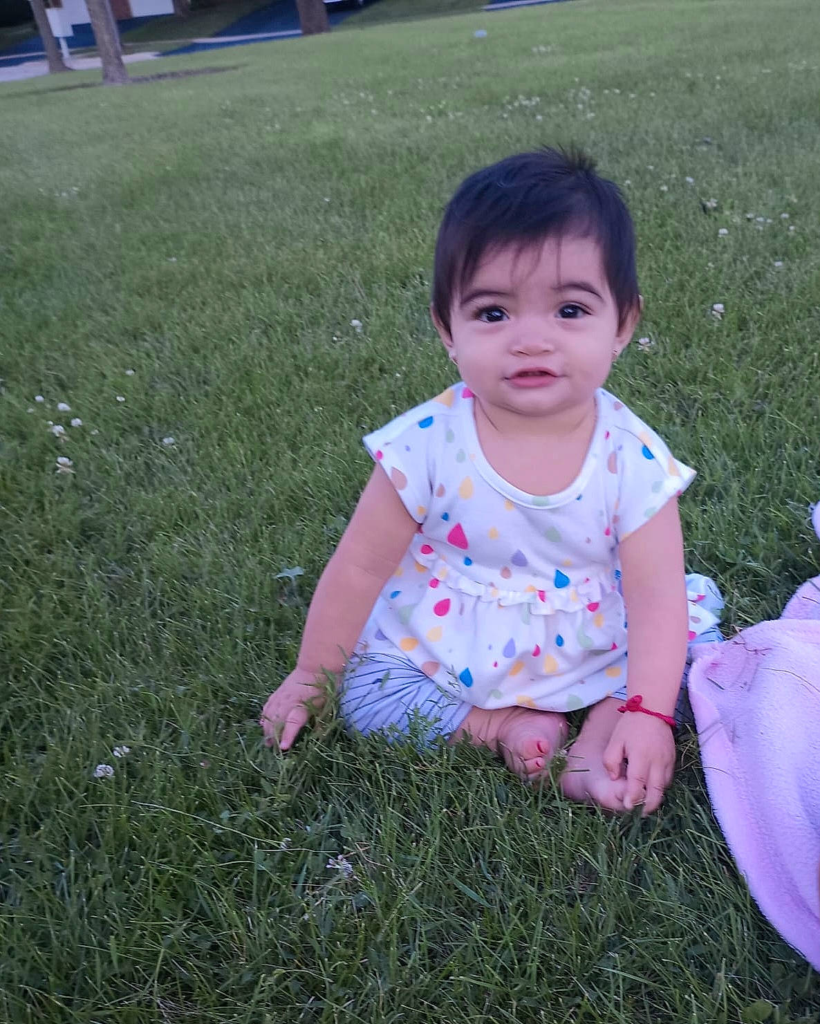 Esther is registered to the contest to win money with this photo: baby, baby_toddler_clothing, child, eye, facial_expression, fun, grass, grass_family, grassland, groundcover, happy, lawn, leisure, meadow, people_in_nature, person, plant, sitting, skin, sleeve