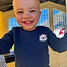 Tiago participe au concours pour gagner de l'argent avec cette photo : child, toddler, smiling, playground, blue_sweater, happy, face, outdoor, sunny, play, cute, young_child, casual_clothing, daylight, person, portrait, joyful, fun, colorful, play_structure