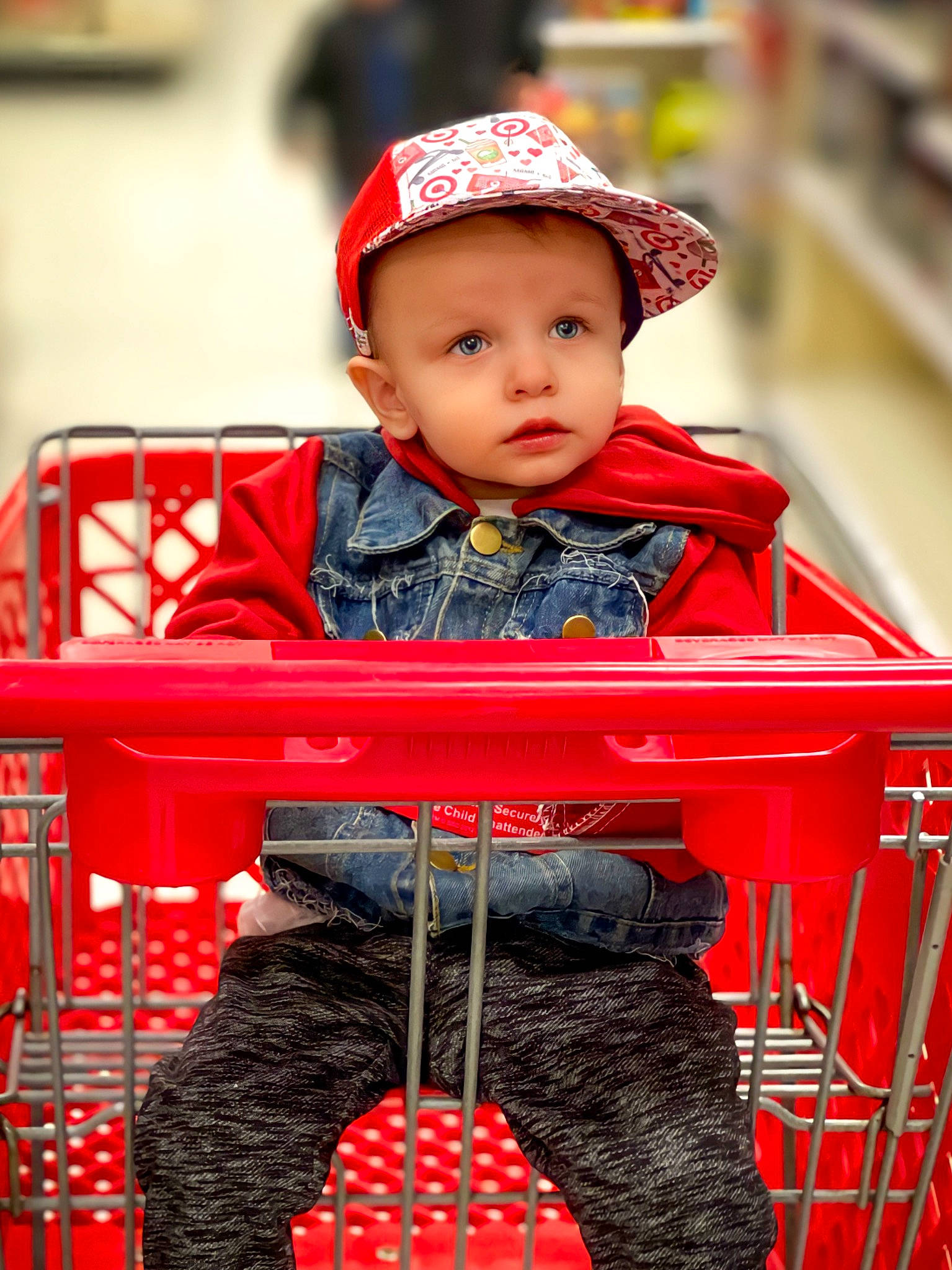 Aslan joined the competition — help win amazing prizes! baby, baby_toddler_clothing, black, cap, cart, child, happy, headwear, pattern, people, person, photograph, red, shopping, shopping_cart, sitting, sleeve, t_shirt, tire, toddler