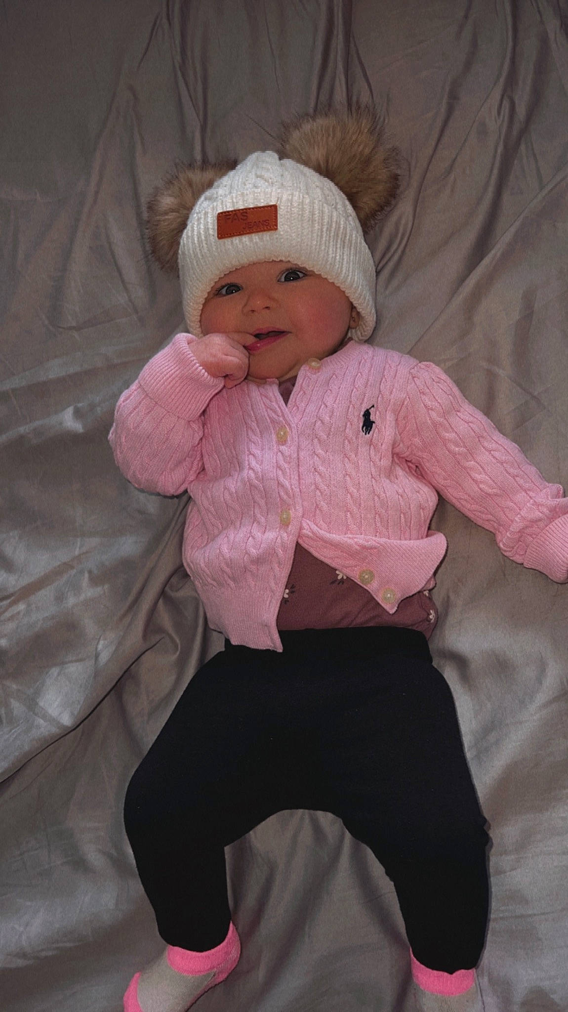 Ava is registered to the contest to win money with this photo: baby, baby_toddler_clothing, cap, cheek, child, comfort, eye, face, fur, head, headgear, headwear, linens, magenta, pattern, person, pink, sitting, sleeve, smile
