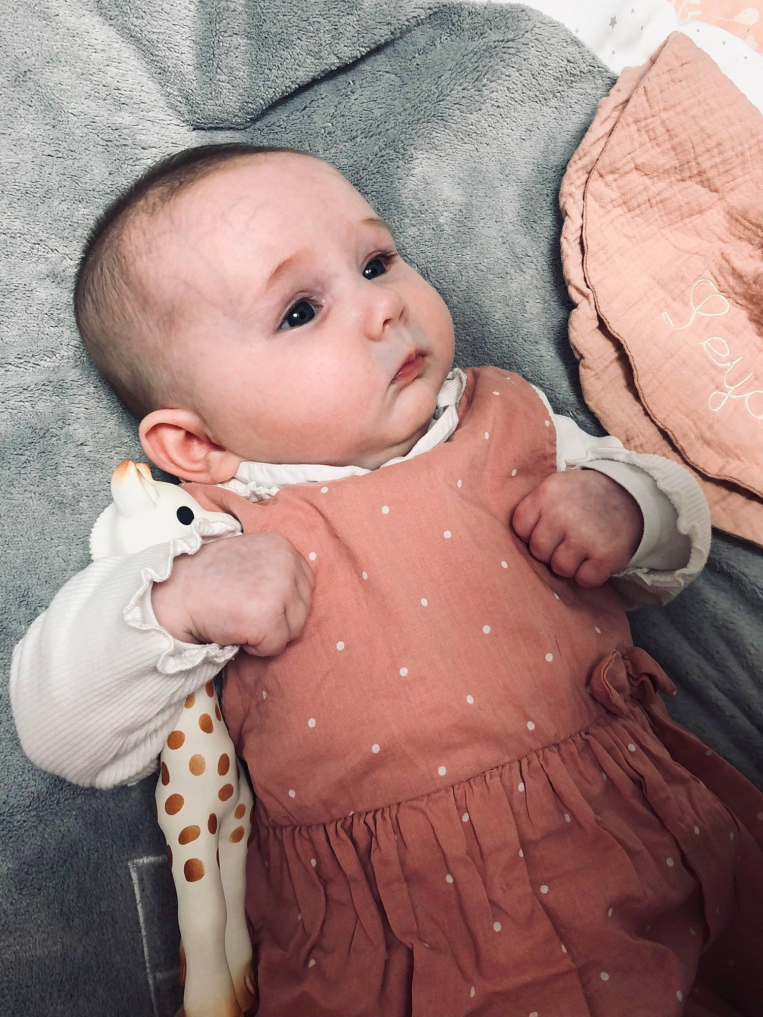 Leya participe au concours pour gagner de l'argent avec cette photo : baby, baby_toddler_clothing, cheek, child, comfort, dress, hand, human_body, iris, lip, nose, outerwear, pattern, person, pink, skin, sleeve, stomach, textile, toddler