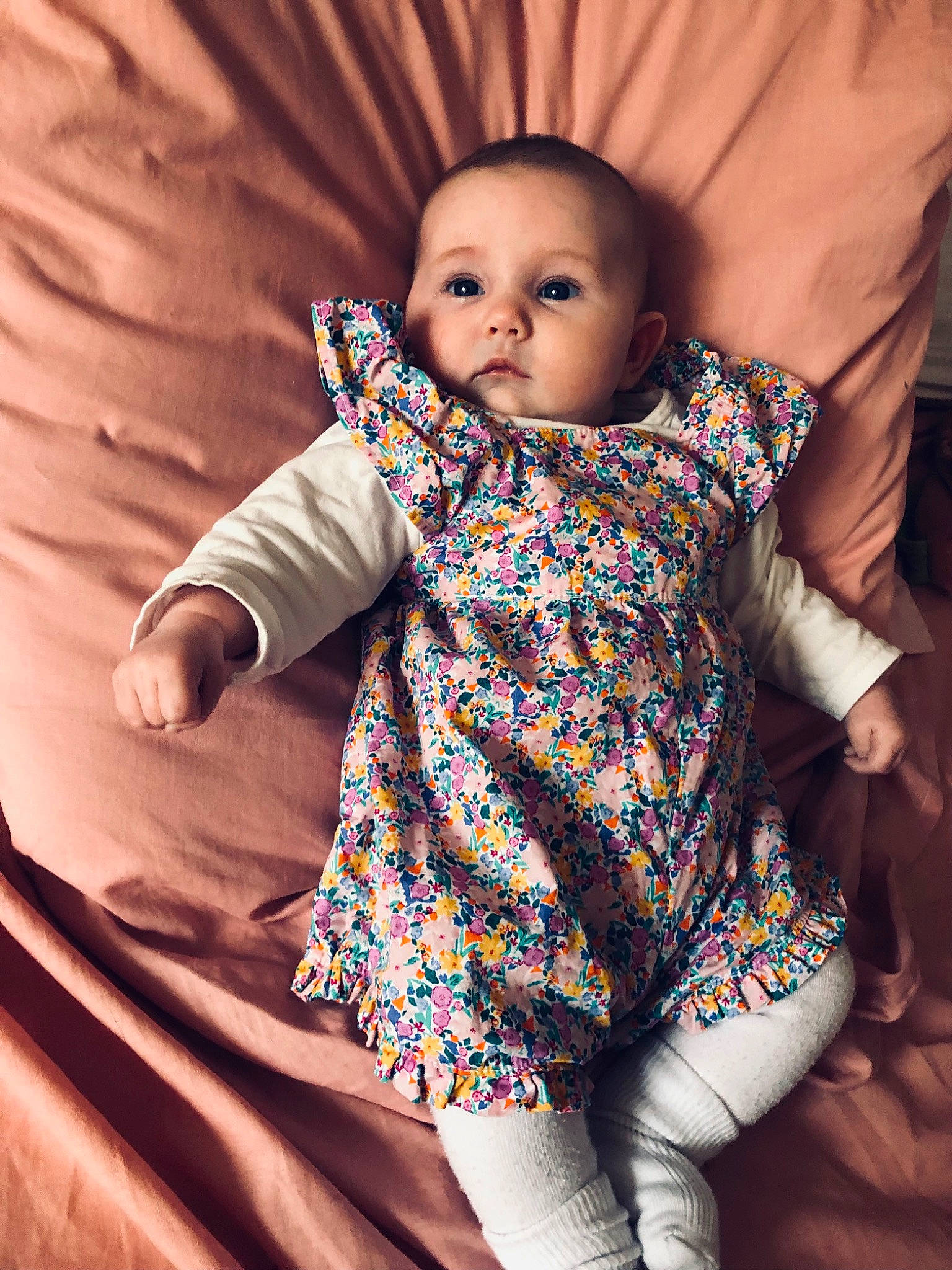 Leya participe au concours pour gagner de l'argent avec cette photo : arm, baby, baby_toddler_clothing, cheek, dress, eye, face, hairstyle, head, human_body, iris, mouth, neck, nose, organ, person, product, skin, sleeve, standing