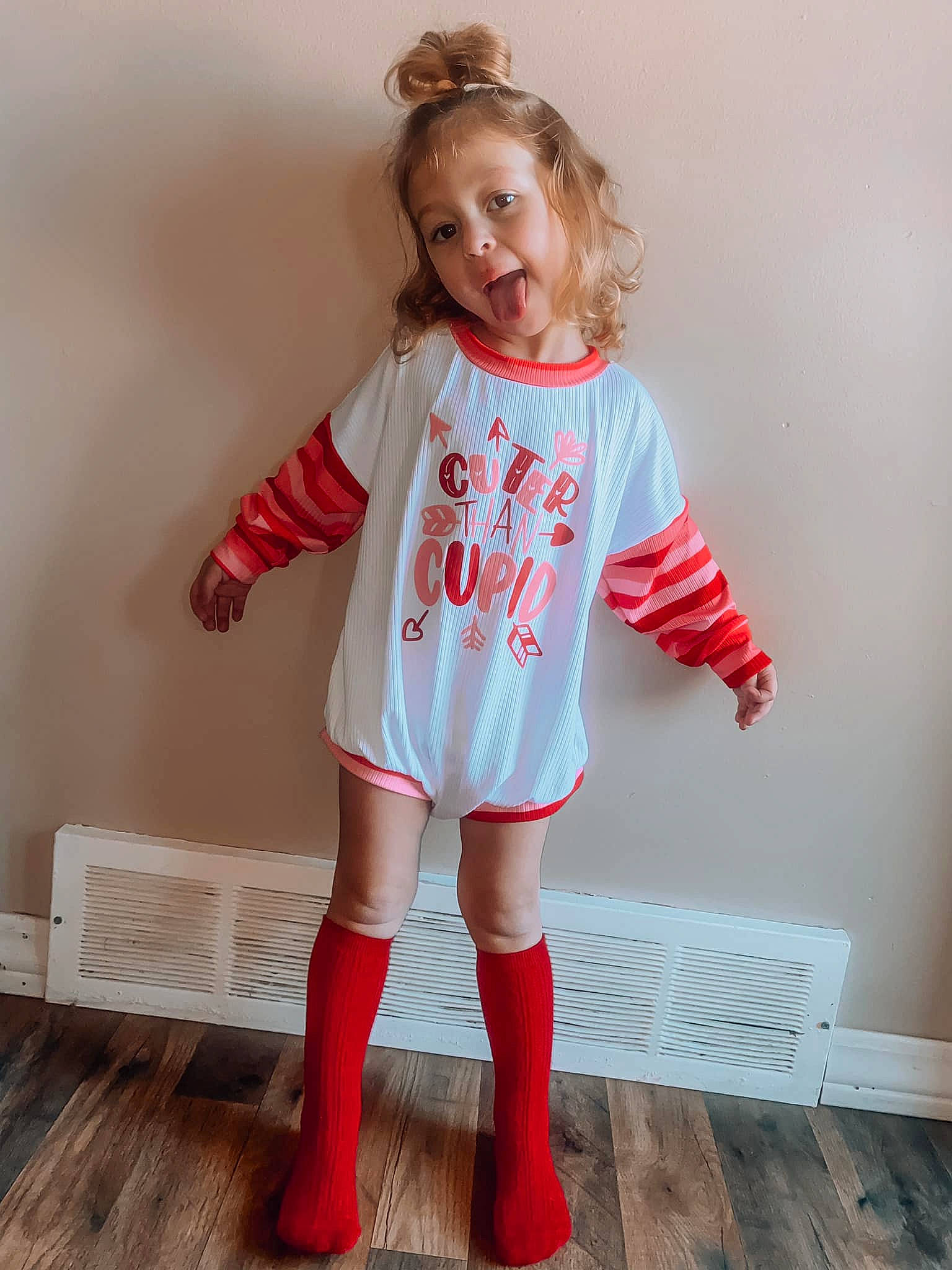 Natalie is registered to the contest to win money with this photo: baby_toddler_clothing, face, floor, flooring, hair, happy, head, human_body, knee, long_hair, neck, person, product, shorts, sleeve, sock, sportswear, t_shirt, thigh, toddler
