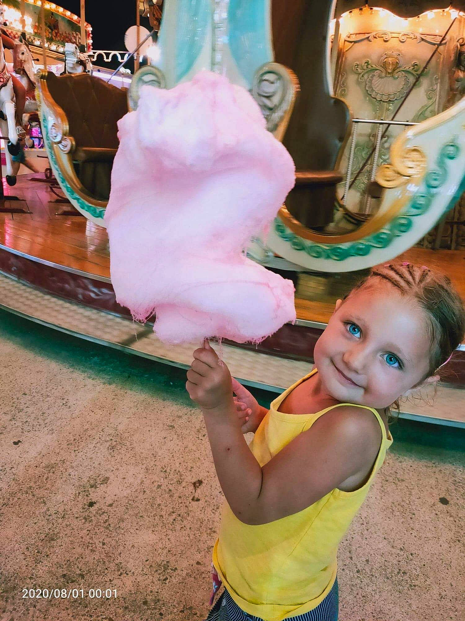 Ina a rejoint le concours — aidez-le/la à gagner de superbes lots ! amusement_ride, baby, carousel, child, city, event, fun, fur, green, happy, joy, leisure, magenta, market, person, pink, recreation, sitting, smile, toddler