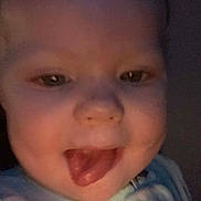 Hadley is registered to the contest to win money with this photo: baby, child, infant, face, portrait, close_up, smiling, laughing, tongue_out, eyes, head, skin, blue_clothing, indoor, dim_lighting, candid, happy, adorable, photography, person
