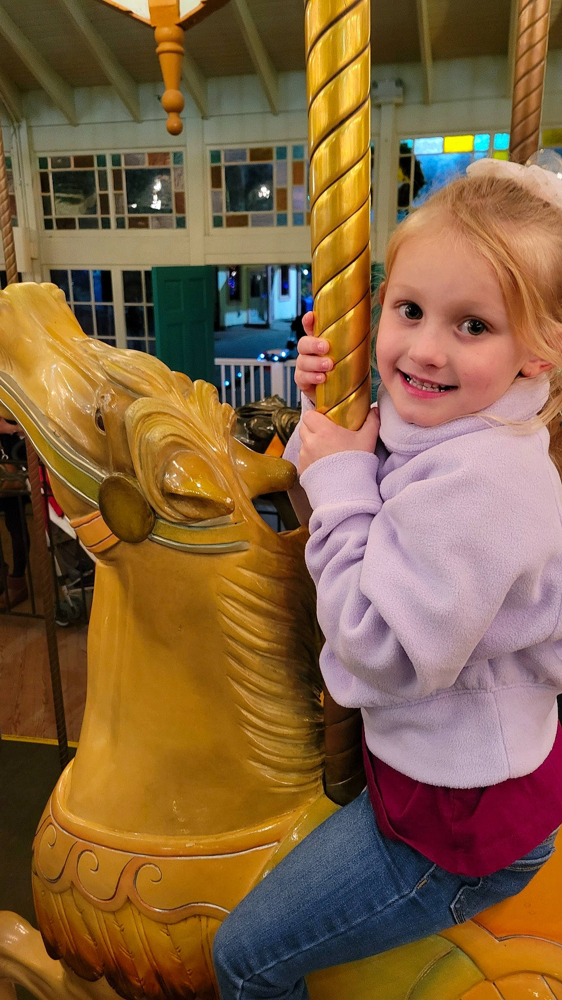 Caroline is registered to the contest to win money with this photo: arm, art, carousel, child, fun, gesture, hand, happy, human_body, human_leg, jeans, joy, leisure, person, play, recreation, sculpture, smile, standing, statue