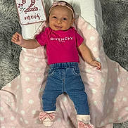 Djena a rejoint le concours — aidez-le/la à gagner de superbes lots ! baby, infant, pink_clothing, headband, milestone_card, givenchy, denim_pants, socks, bows, blanket, polka_dots, smiling, lying_down, face, pillow, carpet, indoor, cute, child, happy