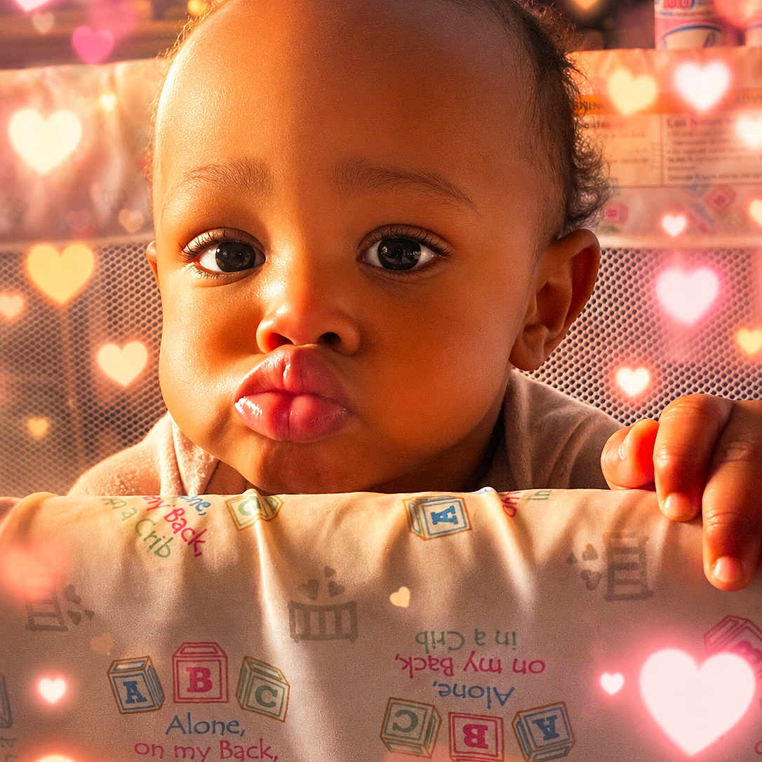 Hikeam Love joined the competition — help win amazing prizes! baby, child, infant, portrait, face, pouting, wide_eyes, curly_hair, smiling, crib, nursery, blanket, hands, indoor, close_up, heart_effects, warm_lighting, adorable, bedding, photograph