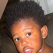 Jayceon is registered to the contest to win money with this photo: background, child, closeup, couch, curly_hair, door, expression, eyes, face, hair, head, indoor, lighting, mouth, person, portrait, skin, teeth, toddler, young_child