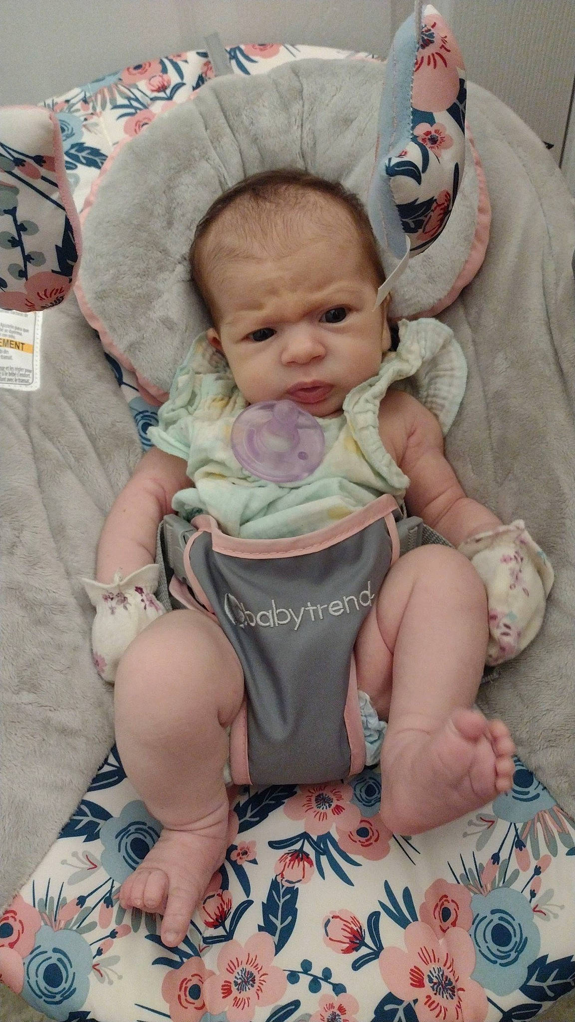 Amara is registered to the contest to win money with this photo: baby, baby_products, baby_safety, baby_sleeping, baby_toddler_clothing, cheek, child, comfort, eye, face, foot, head, human_body, linens, person, pink, room, sitting, skin, toddler