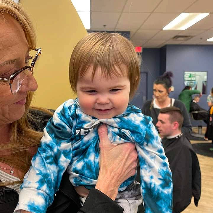 Aster is registered to the contest to win money with this photo: baby, child, couch, ear, event, eyewear, face, fun, glasses, happy, iris, joy, leisure, person, recreation, sitting, skin, smile, t_shirt, toddler