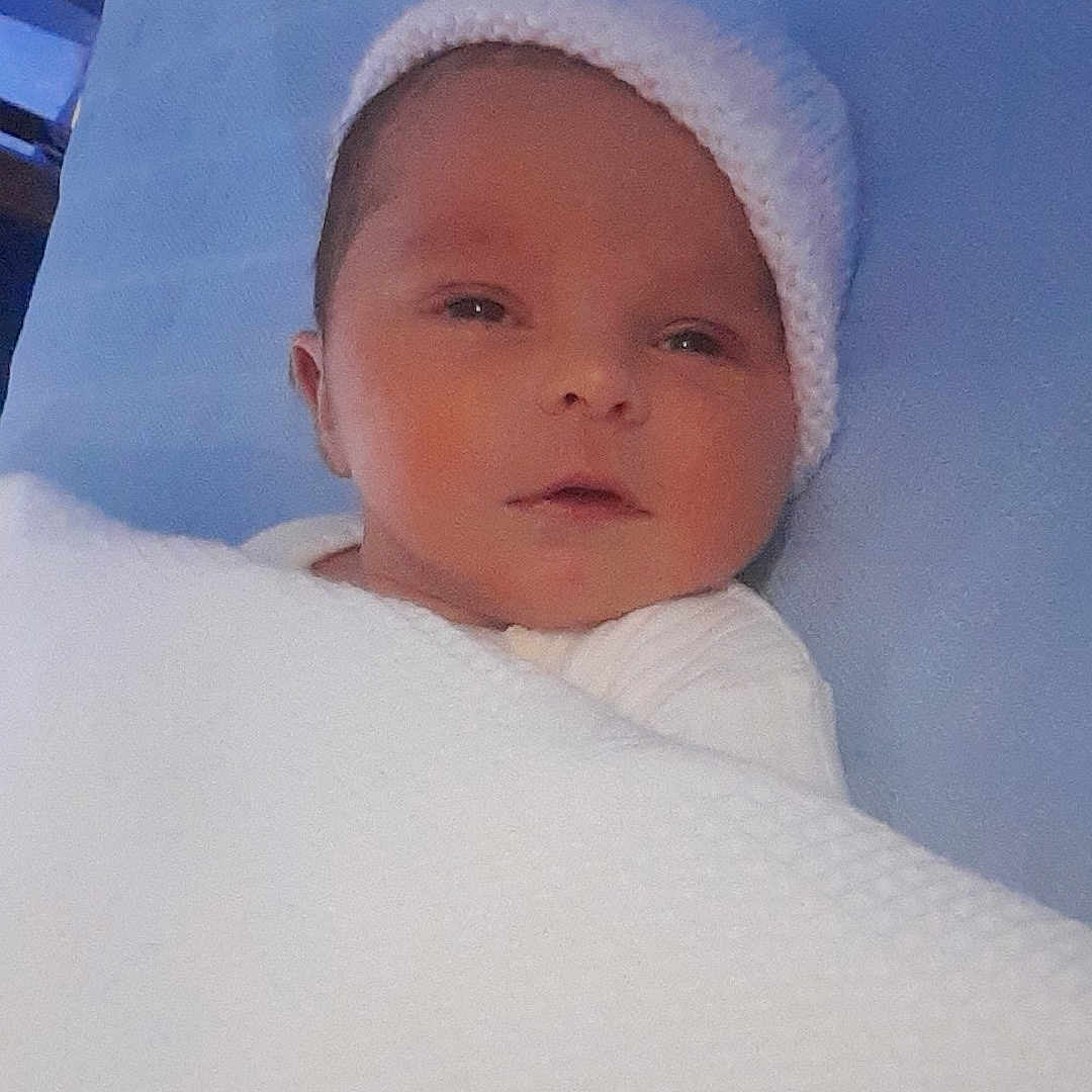 Deeana-Denise is registered to the contest to win money with this photo: baby, blanket, child, cozy, cute, face, hat, indoors, infant, knitted, lying_down, newborn, peaceful, portrait, resting, sleeping, soft, warm, wrapped, young