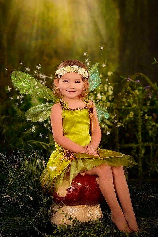 Amber is registered to the contest to win money with this photo: child, day_dress, dress, fawn, flash_photography, forest, fun, grass, hair_accessory, happy, headpiece, headwear, joy, magenta, people_in_nature, person, pink, plant, smile, sunlight
