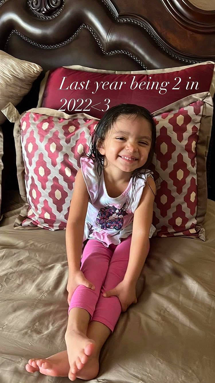 Mani joined the competition — help win amazing prizes! baby_toddler_clothing, barefoot, comfort, cool, flooring, foot, hairstyle, happy, human_leg, joy, knee, magenta, pattern, person, pink, red, room, sitting, smile, textile