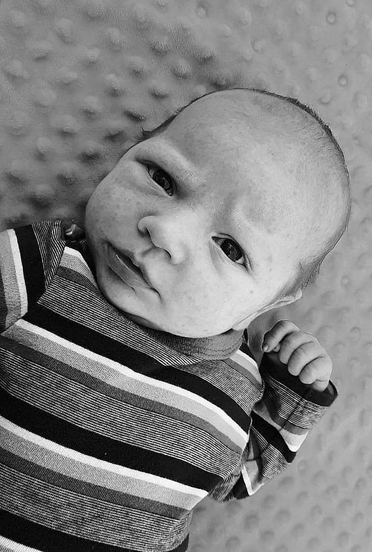 Donald is registered to the contest to win money with this photo: art, baby, baby_products, baby_toddler_clothing, black_and_white, cheek, child, comfort, eye, happy, head, iris, monochrome, monochrome_photography, pattern, person, sitting, skin, sleeve, style