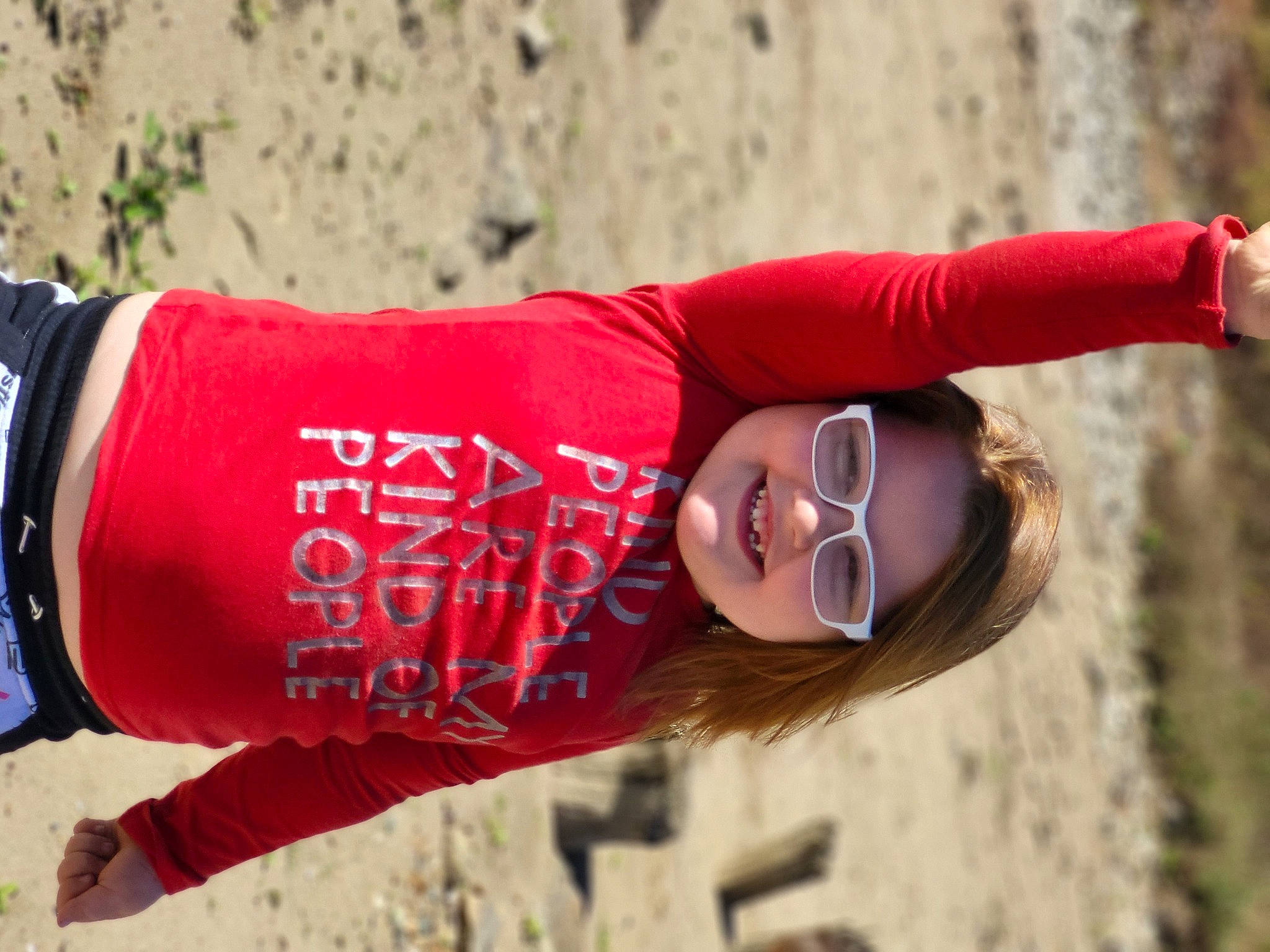 McKenzie is registered to the contest to win money with this photo: adventure, carmine, eyewear, fun, grass, happy, human_leg, joy, landscape, leisure, people_in_nature, person, plant, recreation, sleeve, smile, soil, sunglasses, t_shirt, tree