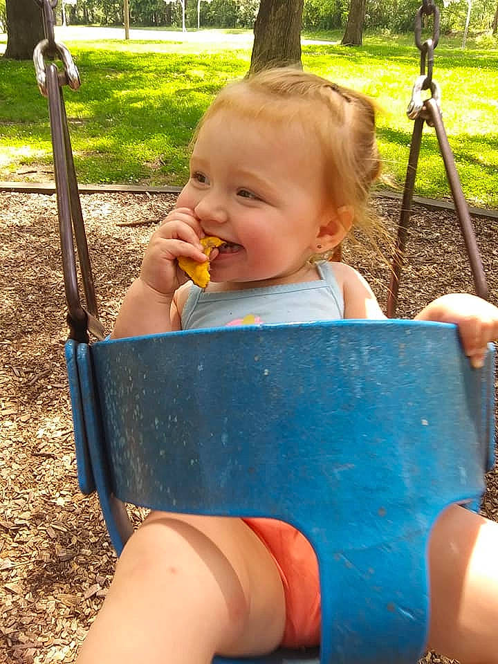 Brandy joined the competition — help win amazing prizes! baby, child, city, fun, human_settlement, joy, leg, outdoor_play_equipment, person, play, playground, public_space, recreation, smile, summer, swing, toddler, vacation