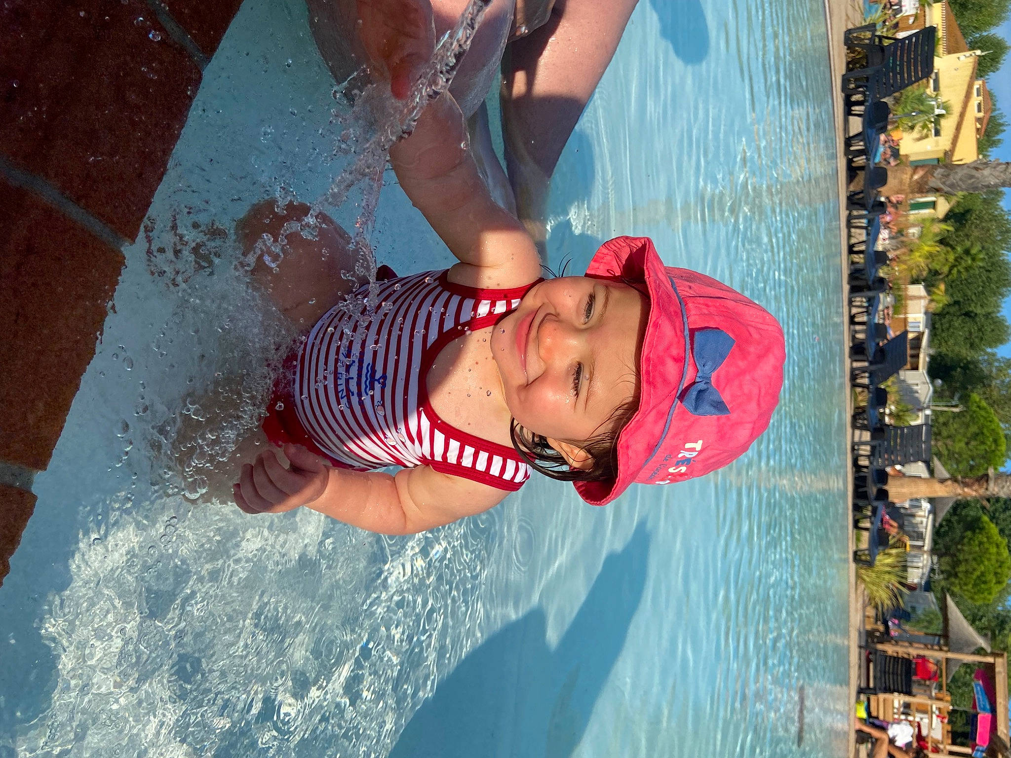 Lizéa participe au concours pour gagner de l'argent avec cette photo : bathing, chest, child, elbow, fun, happy, headwear, joy, leisure, person, personal_protective_equipment, plant, recreation, sky, swimmer, swimming_pool, swimwear, thigh, travel, tree