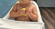 Elijah joined the competition — help win amazing prizes! baby, birthday, cake, celebration, child, curious, curly_hair, face, flooring, food, hands, high_chair, indoor, messy, party, skin, socks, table, toddler, toy