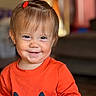 Eliza is registered to the contest to win money with this photo: baby, child, infant, smiling, happy, portrait, close_up, face, red_hair_clip, orange_outfit, pumpkin_costume, long_sleeves, indoor, home, lamp, warm_lighting, blurred_background, seated, cute, photography