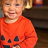 baby, child, infant, smiling, happy, portrait, close_up, face, eyes, brown_hair, orange_clothing, pumpkin_costume, halloween, indoor, home, cozy, sitting, hand, cute, photography