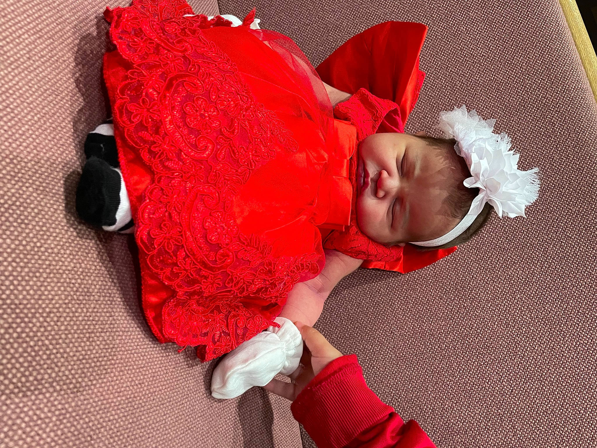 Daelynn is registered to the contest to win money with this photo: baby, baby_toddler_clothing, carmine, child, comfort, event, flooring, happy, lap, linens, magenta, pattern, person, pink, red, room, sitting, sleeve, sock, toddler