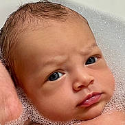 Adam participe au concours pour gagner de l'argent avec cette photo : baby, face, closeup, bath, bubbles, water, skin, head, wet_hair, expression, child, infant, portrait, cute, human, young, indoors, person, newborn, relaxation